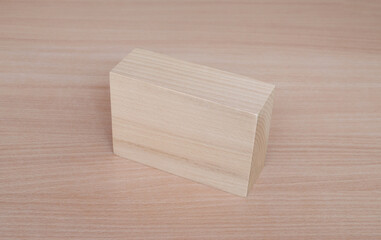 Wooden cuboid geometric model shape on wood table background. Perfect geometry bodies concept