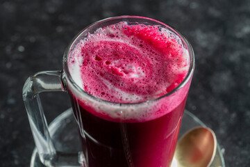 Beetroot vanilla latte from fresh beetroot juice blended with vanilla and milk in a transparent cup...