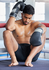 Fototapeta premium Mma, boxer and man sad, loss and defeat in ring from sports boxing match at the gym or arena. Angry male athlete in fight club, fatigue and depression from fighting sport workout or training exercise