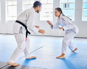 Karate, martial arts and man and woman fight, battle or practice fighting skill during training,...