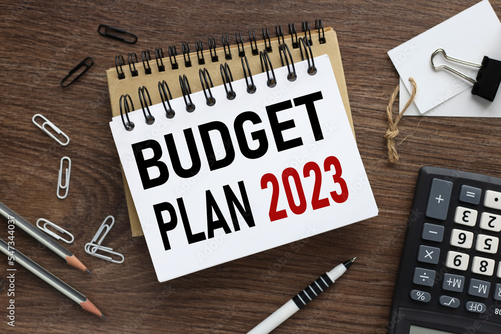 Poster business concept of planning 2023. top view of work desk and text on open notepad. new year business