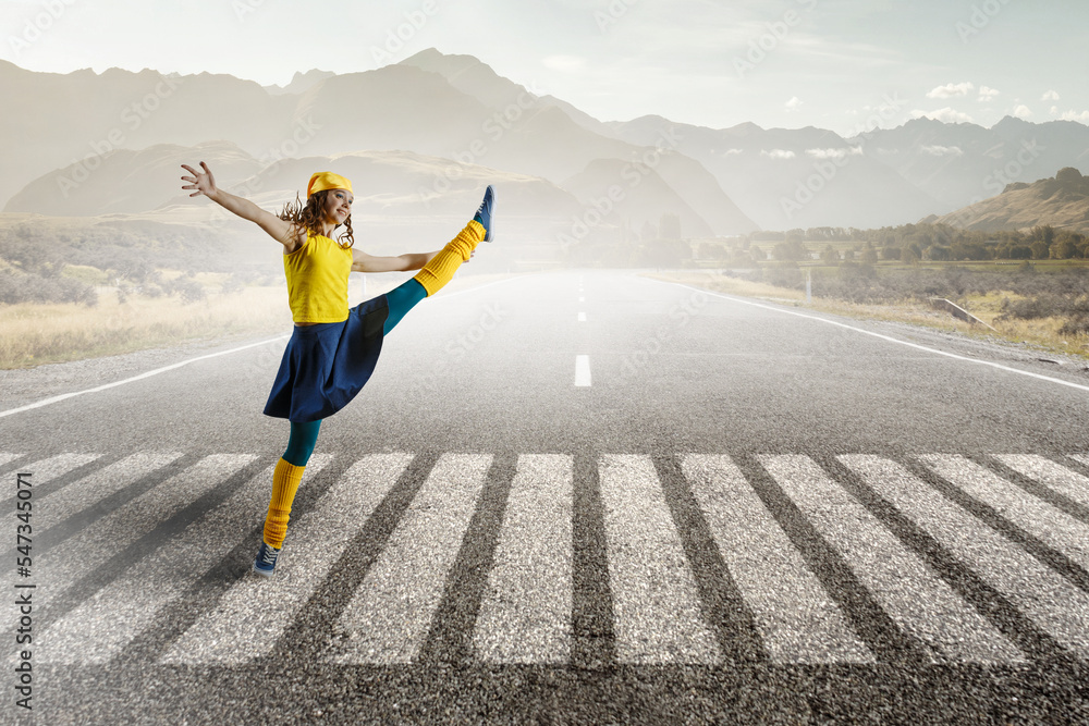 Wall mural young woman jumping in the air