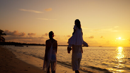 Family With Child Together On Beach