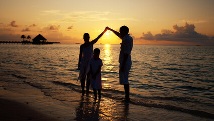 Family In Sunset On Beach. Happy Parents