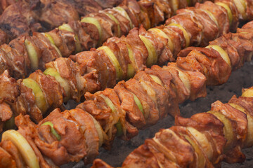 Pieces of meat and onion threaded on metal skewers and grilled over hot coals. Shashlicks. Picnic food