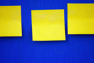 Selective focus. Yellow stickers on a blue board. Yellow and blue.