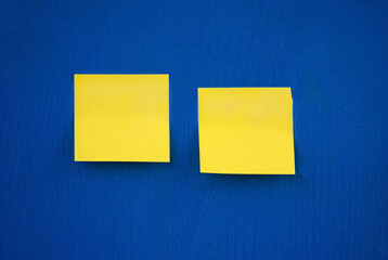 Selective focus. Yellow stickers on a blue board. Yellow and blue.