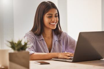 Email, typing and business woman on laptop for research, internet connection and work at home. Social network, working and remote employee with a smile for entrepreneurship with a computer at a desk