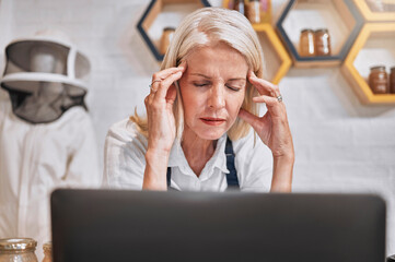 Headache, stress and honey with a retail woman beekeeper suffering from burnout in her sale store....