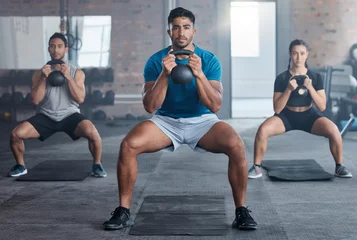 Foto op Plexiglas Fitness Fitness, kettlebell and personal trainer with a man coach training a class in the gym for health. Exercise, workout and bodybuilder with a male athlete teaching students in a club for strong muscles