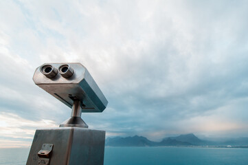 Coin Operated Binocular viewer next to the waterside promenade in Antalya looking out to the bay and city.