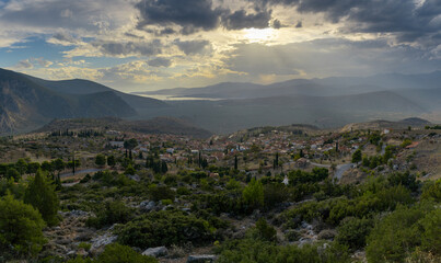 Obraz premium view of the village of Chrisso and the Crissaean Gulf in Central Greece after an evening thunderstorm