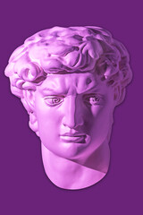 Gypsum copy of head statue David for artists isolated on purple background. Face famous sculpture youth of David by Michelangelo. Template design for dj, fashion, poster, zine. Bright violet color.