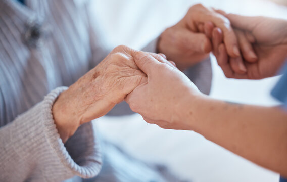 Elderly woman hands, support and holding healthcare worker for medical care or help walking. Retirement care, senior person and holding hands for volunteer caregiver service in health community