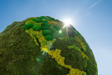 Green planet Earth from natural moss. Symbol of sustainable development and renewable energy	