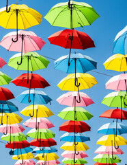 Fototapeta na wymiar Colorful Umbrellas Over the Street