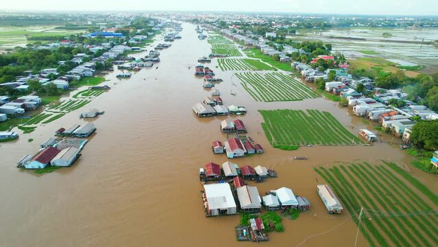 Floating village along Hau river over Vietnam border area, aerial view. The river basin contains a lot of seafood and alluvium for agriculture and economic development in the Mekong Delta