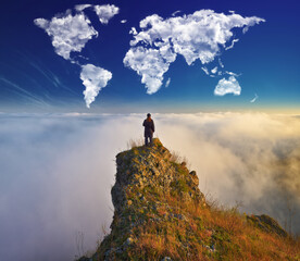 clouds in the form of a world map over the river canyon. tourist on the rock enjoys the view....