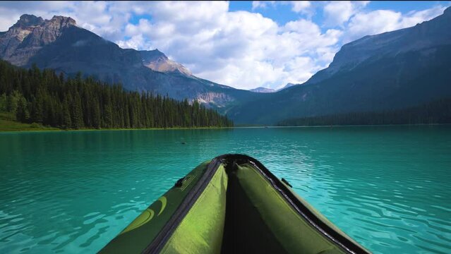 Canoe On Serene Turquoise Mountain Lake In Canadian Rockies