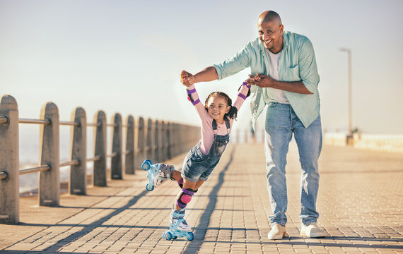 Skating, learning and father holding hands of his child while teaching her on the beach promenade. Family, love and dad helping his young girl kid for support, balance and care to outdoor rollerskate