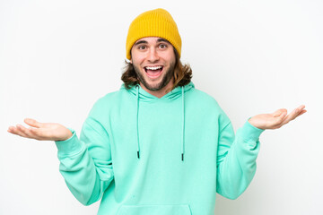 Young handsome man isolated on white chroma background with shocked facial expression