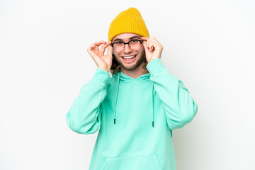 Young handsome man isolated on white chroma background with glasses and surprised