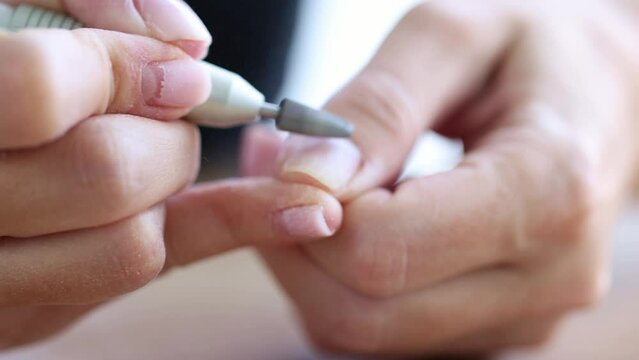 Removing shellac from the nails with fraser. Closeup. Selective focus. 4K