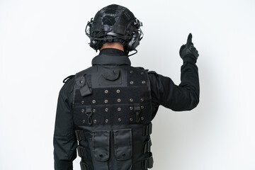 SWAT man over isolated white background pointing back with the index finger