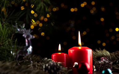 Two burning red candles on the New Year's table