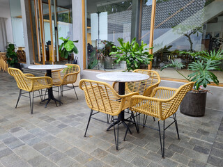 Set of furniture for the garden or terrace.  comfortable chairs and tables in a vintage setting. ...