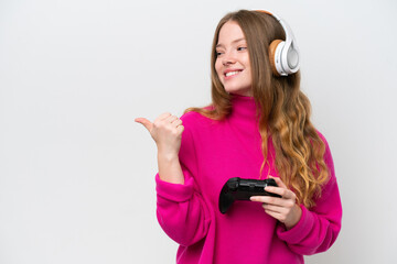 Naklejka premium Young pretty woman playing with a video game controller isolated on white background pointing to the side to present a product