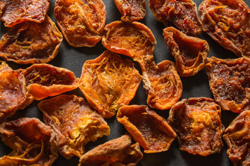 dried apricots on a dark background scattered dried fruits