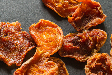 dried apricots on a dark background scattered dried fruits