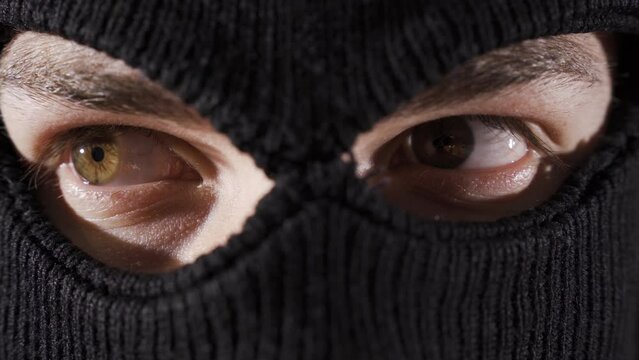 Close-up masked assassin, soldier or thief.
Close-up of man in ski mask.
