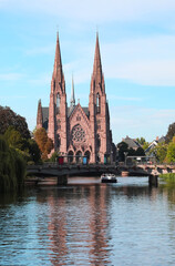 Fototapeta na wymiar St Paul's Church in the city Strasbourg and the navigable river ILL i