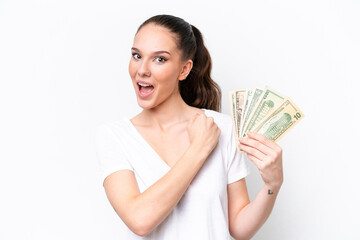 Young caucasian woman taking a lot of money isolated on white background celebrating a victory