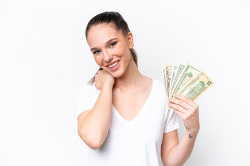 Young caucasian woman taking a lot of money isolated on white background laughing