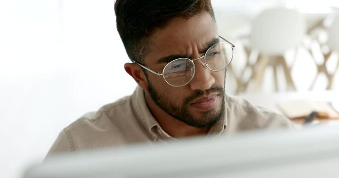 Confused, thinking and computer of businessman with glasses reading website information, marketing analytics and seo analysis in office. Focus, research and problem solving business man on desktop pc