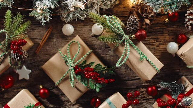 Wooden table with box of Christmas presents and decorations