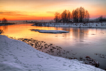 Winter landscape, amazing sundown in winter , Poland Europe, river valley Knyszyn Primeval Forest	