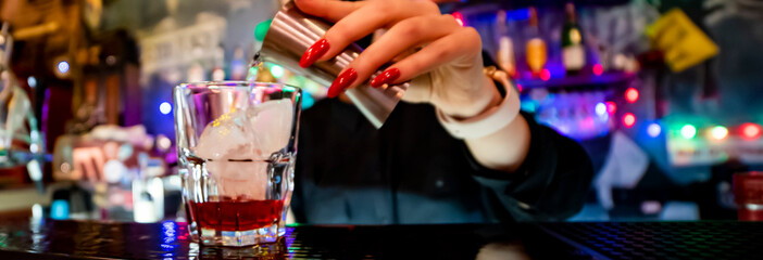 making negroni cocktail. Negroni classic cocktail and gin short drink with sweet vermouth, red bitter liqueur in bar