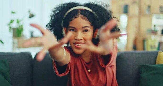 Music, dance and woman singing with energy while streaming rap, hip hop or radio sound on headphones. Wellness, sofa dancing and gen z black girl, singer or crazy dancer listening to fun audio song