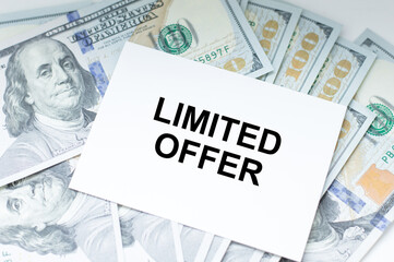 Limited offer, Text on a card on the background of dollar bills on the table, business concept