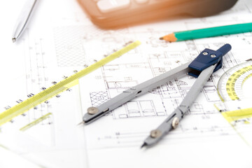 Designing a building or architecture with a ruler, pen, pencil, calculator and other equipment