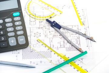 Designing a building or architecture with a ruler, pen, pencil, calculator and other equipment