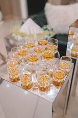 Close up selective focus a flight of whiskies. Four different whiskies in whisky tasting glasses. 