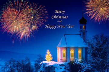 romantic illuminated christmas chapel with xmas tree  in front of blue sky and multi colored...