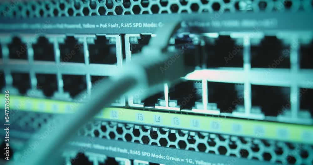 Poster close-up of hand plugging ethernet cable into port of network internet switch