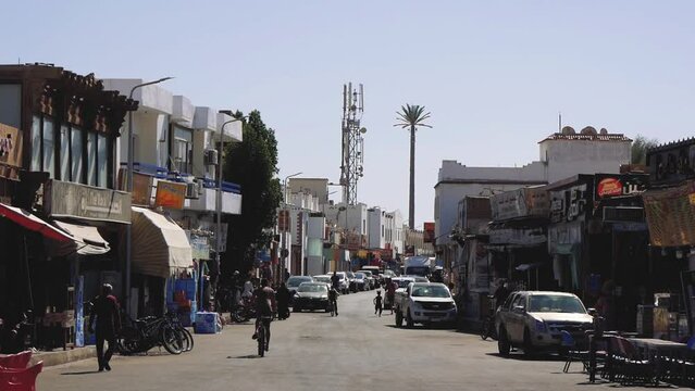 Shopping Street Of A Middle Eastern Town With Pedestrians And Cyclists