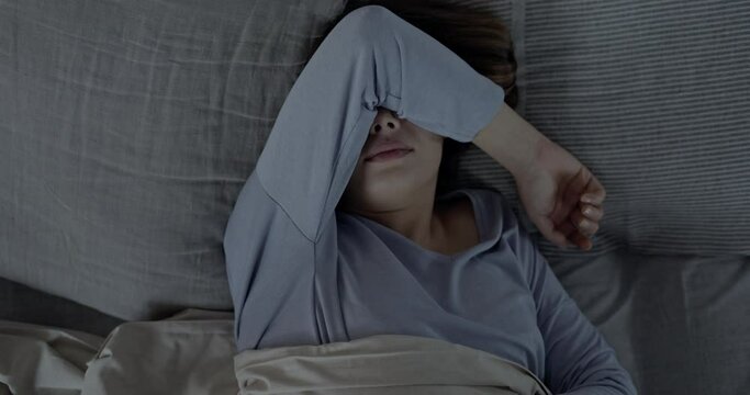 Insomniac young woman in bed